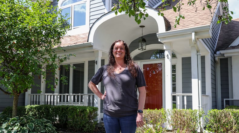 Kathyn Tolbert poses in front of her home in western Troy on Wednesday, Sept. 3. She recently purchased the property and moved from Butler Township. Ohio’s real estate market emerged as one of the most dynamic in the country during the first half of 2025. The state recorded the second most substantial property value changes nationwide with home prices rising by 18% from January to June. BRYANT BILLING / STAFF