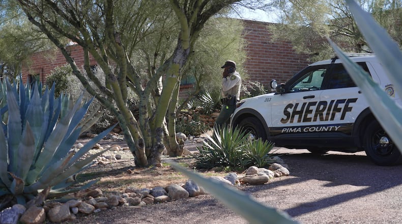 A Pima County sheriffs official stays outside of Nancy Guthrie‘s home on Saturday, Feb. 14, 2026 in Tucson, Ariz. (AP Photo/Ty O'Neil)