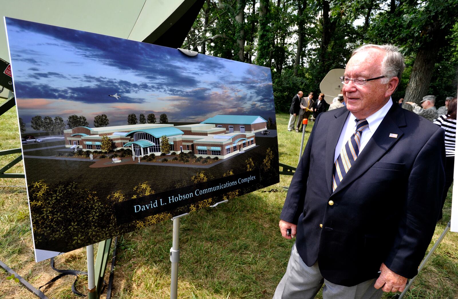 Former U.S. Rep. David Hobson looks over the artist rendering of the new David L. Hobson Communications Complex at the Springfield Air National Guard Base Friday during the ground-breaking ceremony for the complex. Hobson was instrumental in securing the funding for the project. Staff photo by Bill Lackey