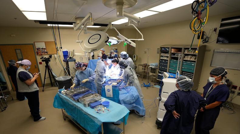 FILE - An organ recovery team works to remove the liver and kidneys from a donor June 15, 2023, in Jackson, Tenn. (AP Photo/Mark Humphrey, File)