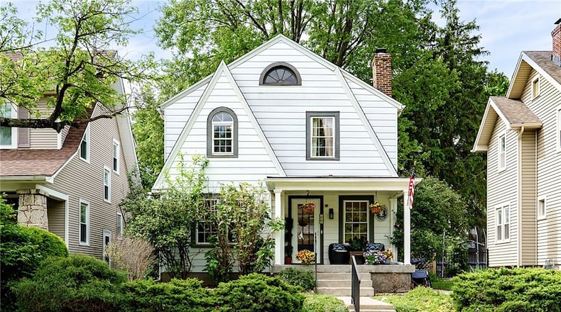 This 1928 Oakwood home has a covered front porch and historical charm including arched windows and hardwood floors.