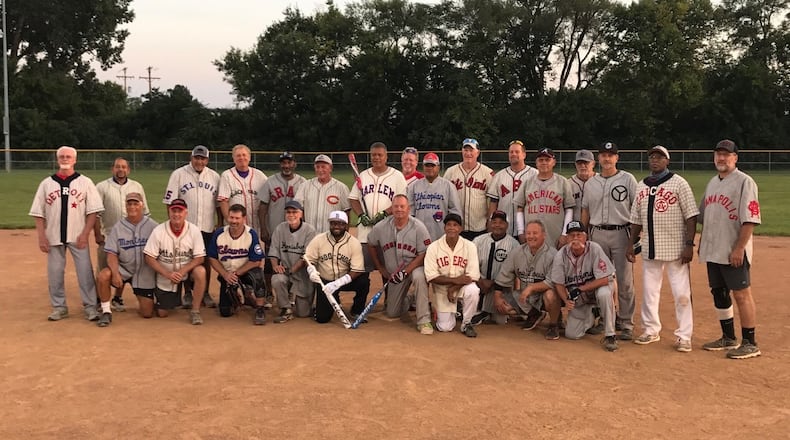 Area senior league players wearing Negro League jerseys in Fairborn Monday night. Tom Archdeacon/STAFF