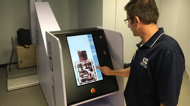 Workers install a new body scanner in the Greene County jail that is intended to help curb the flow of illegal drugs into the jail and stem a spike in inmate overdoses.