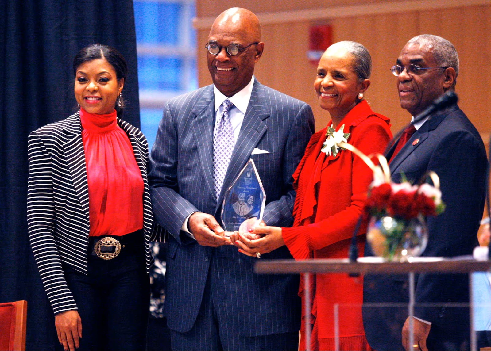 Academy award-winning actress Taraji P. Henson, left, honors 2011 inductees Ernie and Della Green, middle, with Central State University President John Garland, right, during the university's A Night for Philanthropy at the Schuster Center in 2011. FILE PHOTO