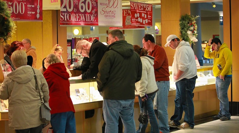 Shoppers look at inventory Monday afternoon at a busy Kay Jewelers at the Dayton Mall.