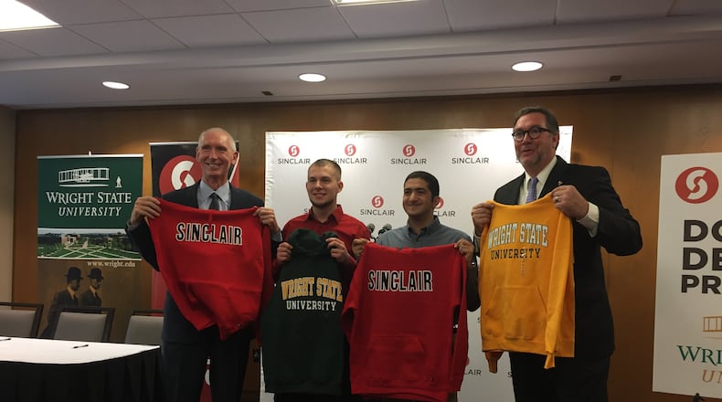Wright State Provost Tom Sudkamp, left, students Tyler McDonugh and David Bebawy, and Sinclair President Steven Johnson attend an event in honor of the renewal of the Double Degree Program. McDonugh and Bebawy will attend WSU in the fall as part of the program. MAX FILBY / STAFF