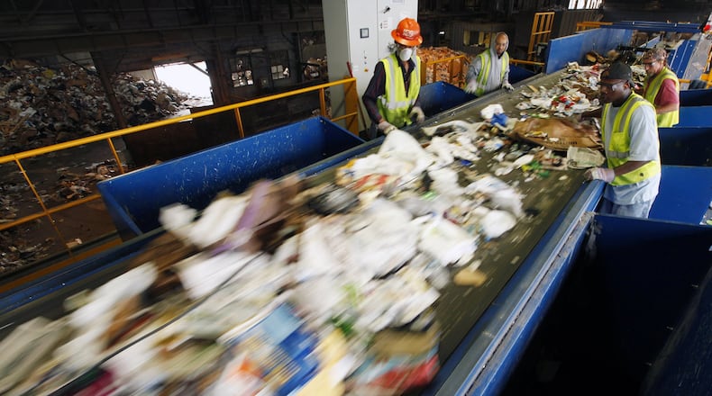 This file shows workers along a new pre-sorting machine at Rumpke Recycling in Dayton. Tightened rules from China are forcing companies to find new markets for recycled products and cut down on the amount of material that should not be put into recycling bins. TY GREENLEES / STAFF