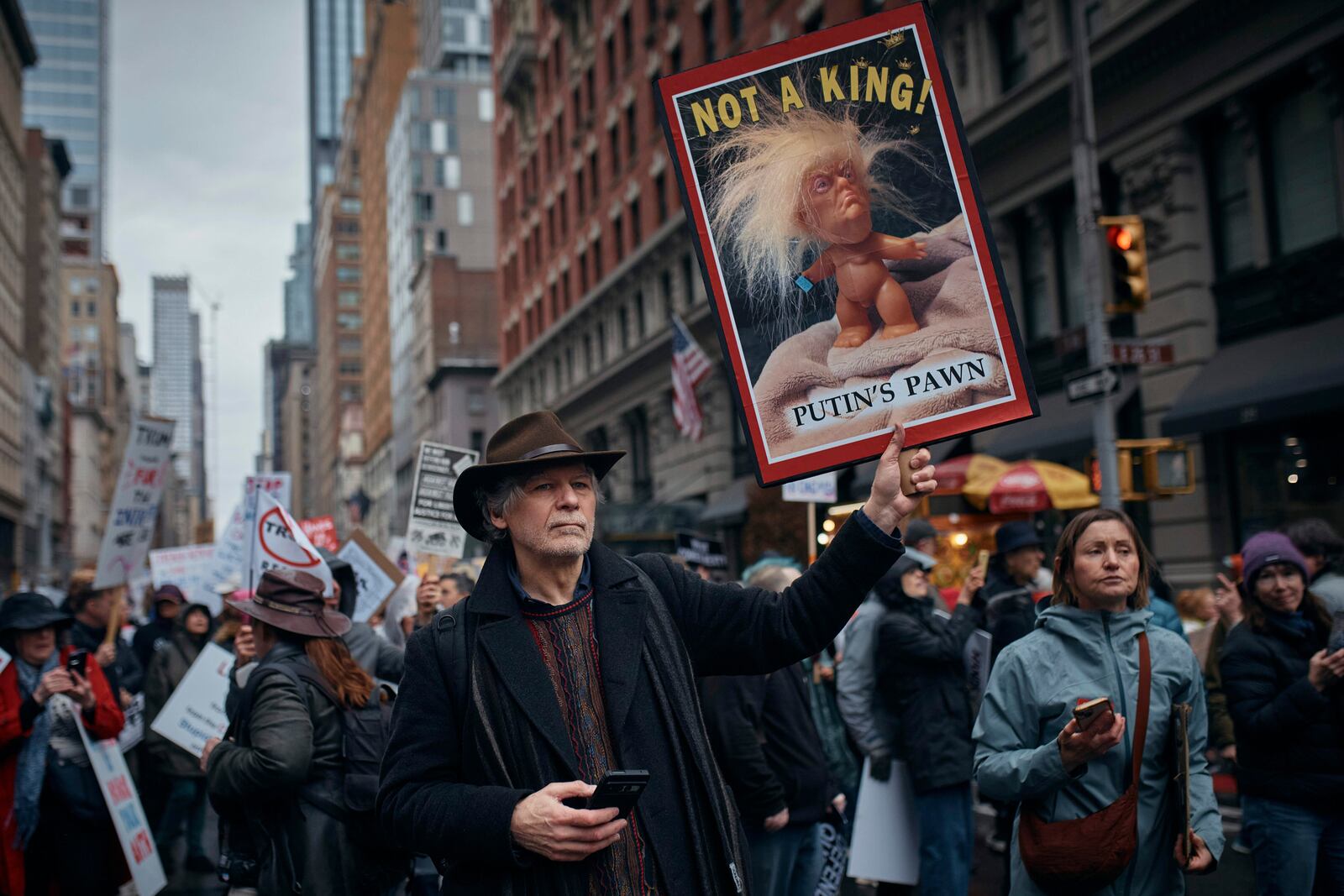 Protestors hold signs as they take to the streets and march during a "Hands Off!" protest against President Donald Trump on Saturday, April 5, 2025, in New York. (AP Photo/Andres Kudacki)