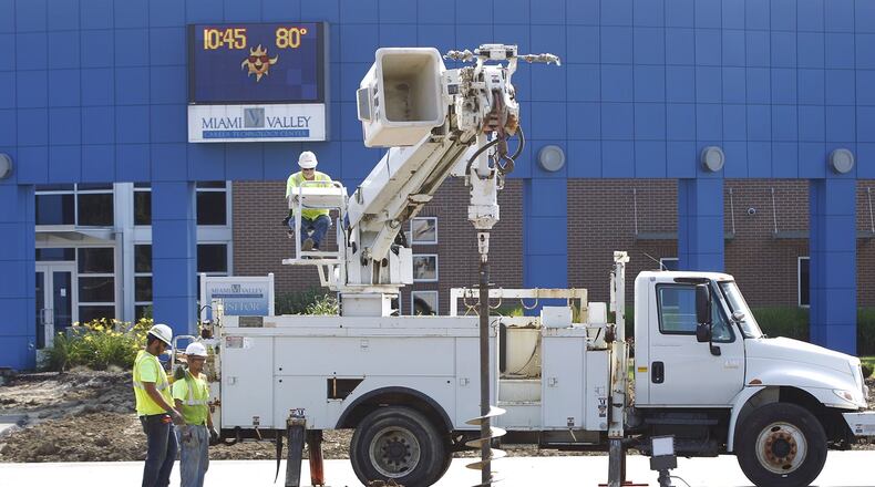 Electrical contractors begin installation of a new lamp at the main entrance of the Miami Valley Career Technology Center as part of significant work on upgrades and expansion this summer. The CTC has reworked the parking lot and entrance/exit into the facility and land for new buildings have been leveled for foundation work. A bond issue/tax levy was passed in 2017 for a five-year campus makeover to establish one building, instead of the current multiple buildings, for safety concerns of the students. TY GREENLEES / STAFF