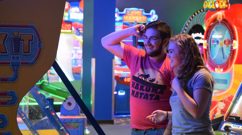 Kylie Salamon and Rett Genatempo play an arcade game at the New Round1 in the Mall at Fairfield Commons Saturday during an exclusive soft opening. This is the second Ohio location filling the lower floor of a vacant Sears. STAFF PHOTO / HOLLY SHIVELY