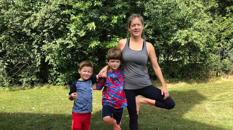 Elissa Dinsmore with her sons, Owen, 8 (left) and Johnny, 11. the family has been practicing yoga together for several years and the boys have helped their mom refine her kids yoga classes. CONTRIBUTED