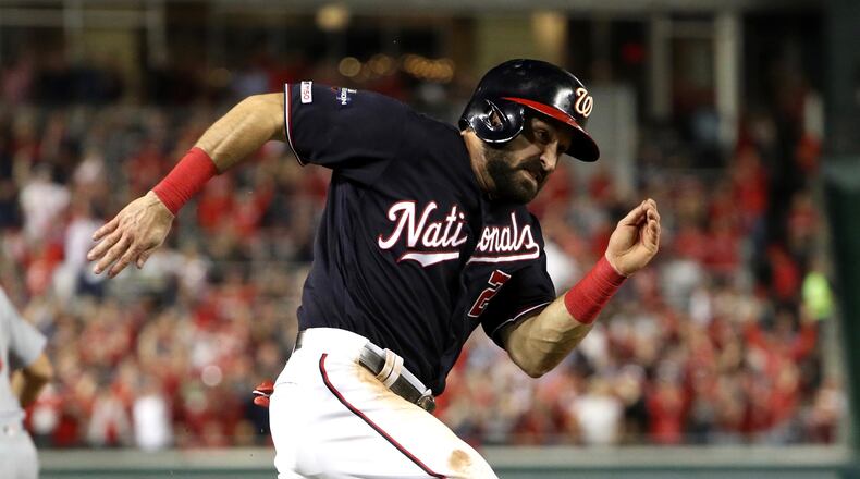 The Nationals' Adam Eaton runs home to score during the third inning of game three of the National League Championship Series against the St. Louis Cardinals at Nationals Park on October 14, 2019 in Washington, DC. (Photo by Patrick Smith/Getty Images)