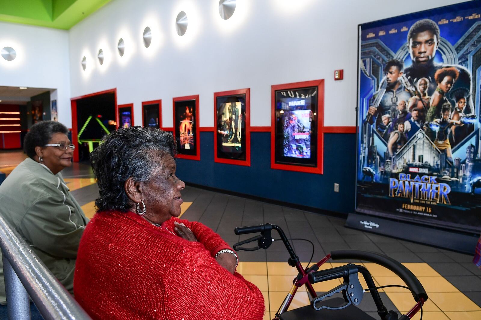 Janie Banks, left, and Mildred Johnson, right, wait for the noon showing of the Marvel Comics Black Panther movie at AmStar 14 in Anderson on Monday.