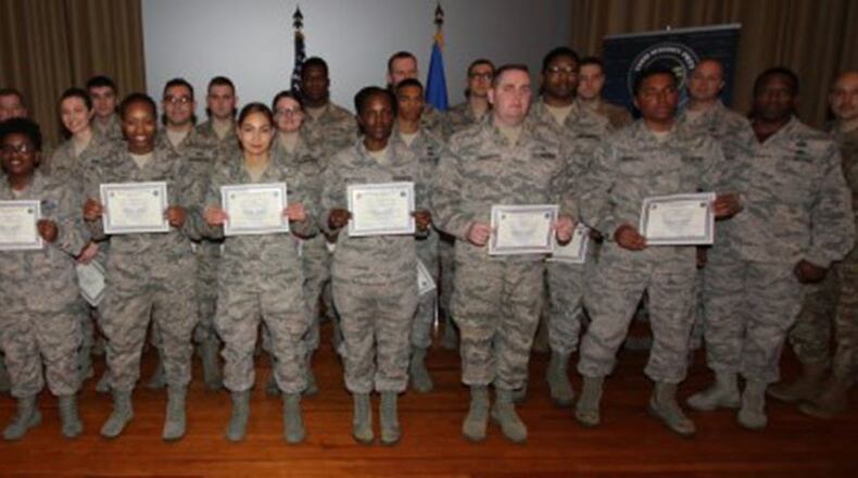 Col. Tom Sherman (second from left), 88th Air Base Wing and installation commander, and Chief Master Sgt. Stephen Arbona (right), 88th Air Base Wing command chief, celebrate the newest Team Wright-Patt enlisted promotees during a ceremony at the Wright-Patterson Air Force Base Theater Dec. 28. (U.S. Air Force photo/Thomas Lewis)