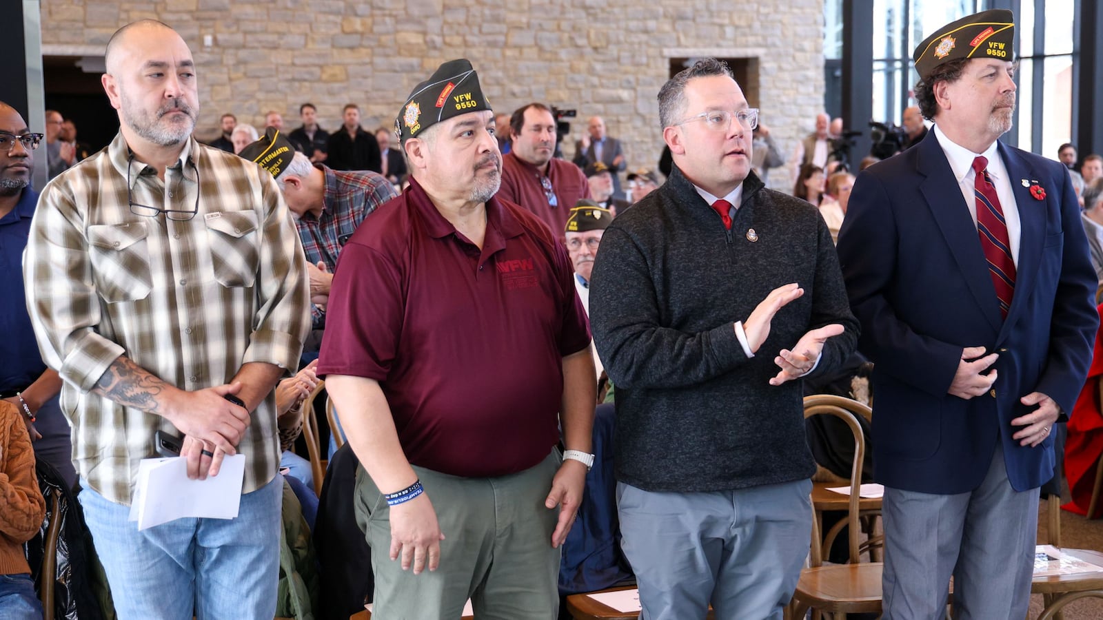 From left to right, Army veteran Tim Pennartz, Air Force veteran Fred Rojas Jr., Army veteran Tony Miltenberger and VFW Post 9550 Commander Richard Hughes stand while veterans are being recognized during a Veterans Day event on Tuesday, Nov. 11 at Benham's Grove in Centerville. BRYANT BILLING/STAFF