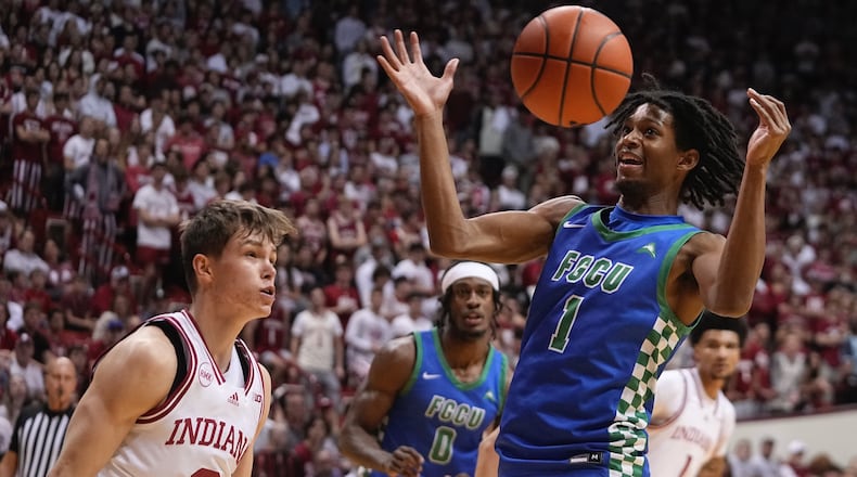Florida Gulf Coast's Rahmir Barno (1) gains control of a loose ball against Indiana's Gabe Cupps (2) during the first half of an NCAA college basketball game, Tuesday, Nov. 7, 2023, in Bloomington, Ind. (AP Photo/Darron Cummings)