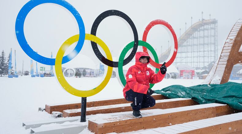 Japan's Goshin Fujiki poses for a photo in front of the Olympic rings at the 2026 Winter Olympics, in Livigno, Italy, Wednesday, Feb. 4, 2026. (AP Photo/Gregory Bull)
