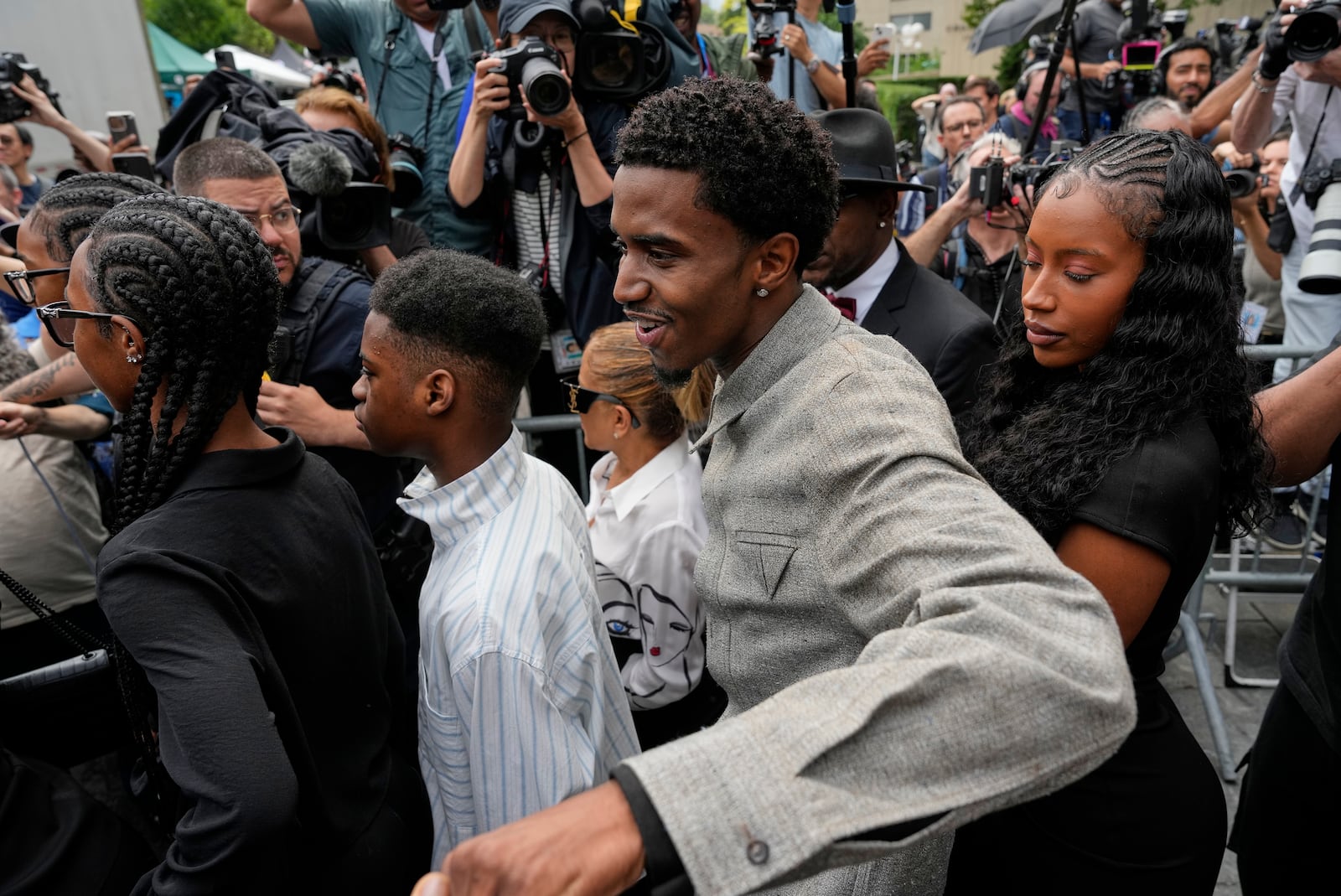 Family members of Sean "Diddy" Combs, react as they leave Manhattan federal court after Combs' was convicted of a prostitution-related offense but acquitted on the most serious charges at his New York trial, Wednesday, July 2, 2025, in New York. (AP Photo/Yuki Iwamura)