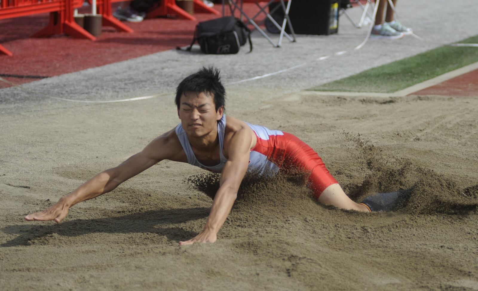 Troy senior Hayata Nagata lands in the long jump pit during the D-I district track and field meet at Wayne High School on Wednesday, May 17, 2017. MARC PENDLETON / STAFF