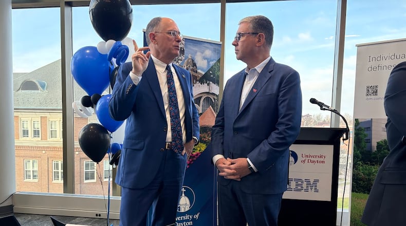 University of Dayton President Eric Spina, left, and James Kavanaugh, IBM senior vice president and chief financial officer, share a word before a campus press conference on Wednesday Nov. 19, 2025 announcing a UD-IBM semiconductor research and education partnership. THOMAS GNAU/STAFF