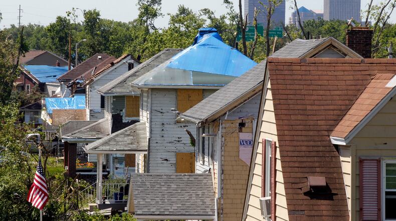 Boarded and tarp covered homes along Rolfe Ave. in Harrison Twp. nearly a month after suffering damage from the Memorial Day tornado.  TY GREENLEES / STAFF