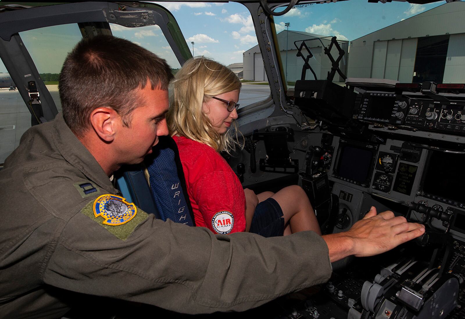 A camper is shown the inside of a C-17 Globemaster III cockpit by Capt. Matthew Bush, 89th Airlift Squadron pilot, at Wright-Patterson Air Force Base on June 14. Air Camp is a STEM program designed to raise interest in aviation among middle school students. U.S. AIR FORCE PHOTO/R.J. ORIEZ