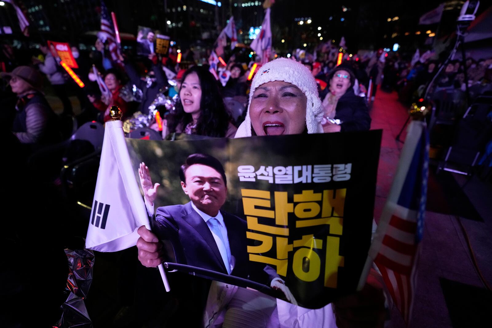 Supporters of impeached South Korean President Yoon Suk Yeol attend a rally to oppose his impeachment in Seoul, South Korea, Thursday, April 3, 2025. The letters read "Dismiss impeachment." (AP Photo/Ahn Young-joon)