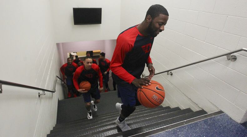 Scoochie Smith leads the Flyers to the court at the Smith Center before a game against George Washington on Saturday, March 4, 2017. David Jablonski/Staff