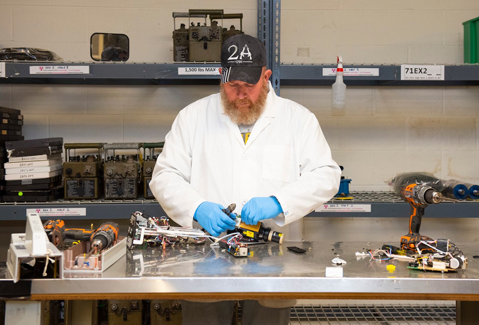 Charlie Mitchell disassembles a piece of equipment to remove the radioactive component at the Air Force Radioactive Recycling and Recycling facility Dec. 1, 2021, at Wright-Patterson Air Force Base, Ohio. AFRRAD receives thousands of items containing recyclable radioactive material each year. U.S. AIR FORCE PHOTO/JAIMA FOGG
