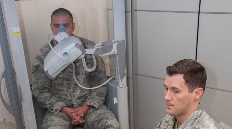 Staff Sgt. Jonathon Lee, pulmonary technician with the Aeromedical Consultation Service Internal Medicine Branch, conducts a demonstration of a pulmonary function test for forced vital capacity as Staff Sgt. Sean O’Neill sits in a pressurized cabin awaiting the command to exhale. The branch reviews around 700 requests for waiver recommendation cases annually concerning pilots, navigators and other aircrew, with 90 percent of them receiving waiver recommendations. (U.S. Air Force photo/John Harrington)