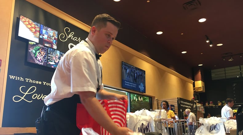 Connor Yoakum, 21, bags groceries at the Dorothy Lane Market store at Washington Square. He will compete at the Ohio Grocery Association’s best bagger competition Tuesday. STAFF PHOTO / HOLLY SHIVELY