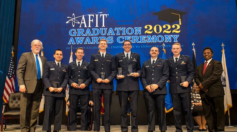 Master of Science in Astronautical Engineering student Lt. Charlie Carr (second from right) was the Air Force Institute of Technology’s Department of Aeronautics and Astronautics’ “Best Thesis” winner for his topic, “Coupled Orbit-Attitude Dynamics and Control of a CubeSat Equipped with a Robotic Manipulator.” This award recognizes the most exceptional master’s thesis by a graduating student within each academic department. Carr is pictured with “Best Thesis” winners from the engineering school’s five academic departments as well as Dr. Walter Jones, AFIT director and chancellor (far left) and Dr. Adedeji Badiru (far right), dean, AFIT’s GSEM. U.S. AIR FORCE PHOTO/JAIMA FOGG