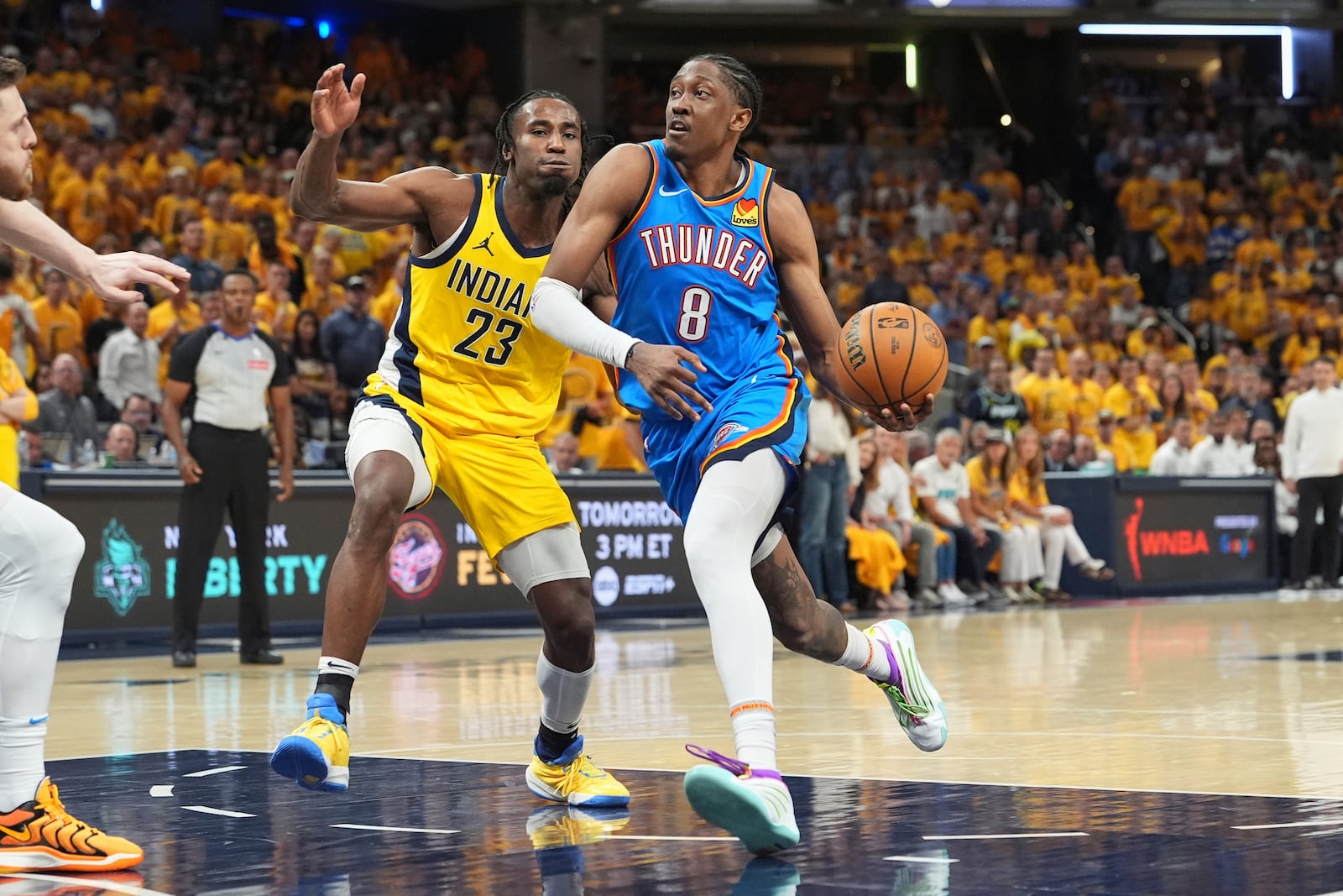 Oklahoma City Thunder forward Jalen Williams (8) drives as Indiana Pacers forward Aaron Nesmith (23) defends during the second half of Game 4 of the NBA Finals basketball series, Friday, June 13, 2025, in Indianapolis. (AP Photo/Michael Conroy)