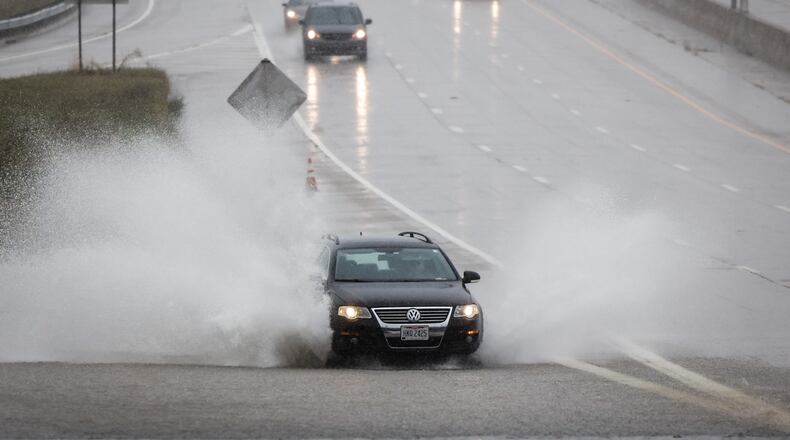 Drivers on SR 35 near James H. McGee Blvd. dodged standing water Tuesday, Aug. 31, 2021, after remnants Hurricane Ida dumped copious amounts of rain in Dayton. JIM NOELKER/STAFF