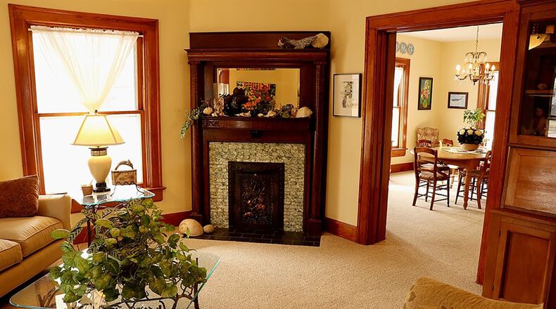 A decorative corner fireplace accents the formal living room, which has pocket doors that open into two other social areas of the main level.