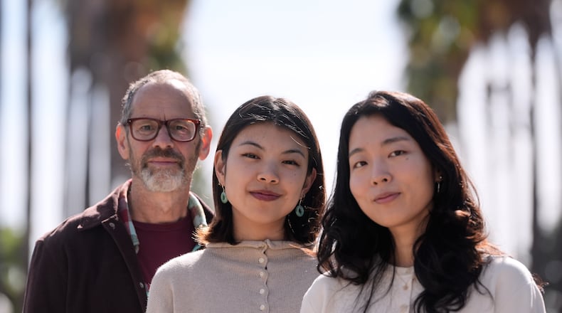 Dan Jurafsky, Stanford professor of computer science and linguistics, from left, Myra Cheng, Stanford Ph.D. candidate in computer science, and Cinoo Lee, Stanford postdoctoral fellow in psychology, pose for photos on the university campus in Stanford, Calif., Thursday, March 26, 2026. (AP Photo/Jeff Chiu)