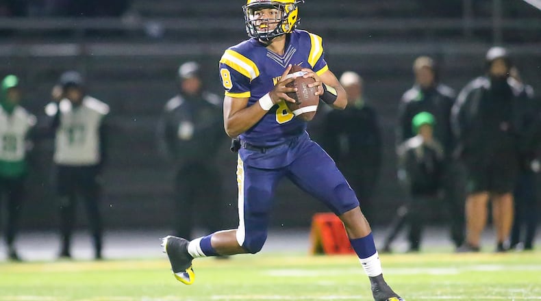 Springfield High School senior quarterback Te'Sean Smoot rolls out to pass during their game against Northmont on Friday night at Springfield High School. Smoot had six total TDs as the Wildcats beat the Thunderbolts 42-7. Michael Cooper/CONTRIBUTED