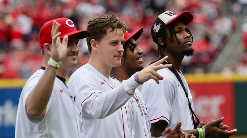 Bengals coach Zac Taylor, quarterback Joe Burrow and wide receivers Ja'Marr Chase and Tee Higgins are honored before the Reds' game against the Guardians on Opening Day on April 12, 2022, at Great American Ball Park in Cincinnati. David Jablonski/Staff