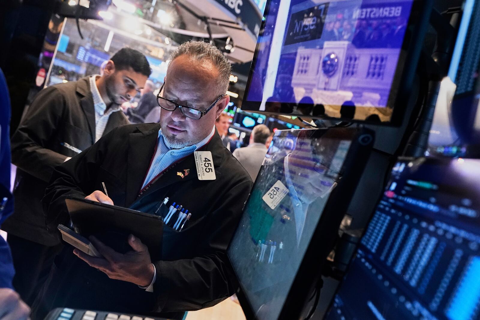 Trader Robert Arciero, right, works on the floor of the New York Stock Exchange, Tuesday, May 27, 2025. (AP Photo/Richard Drew)