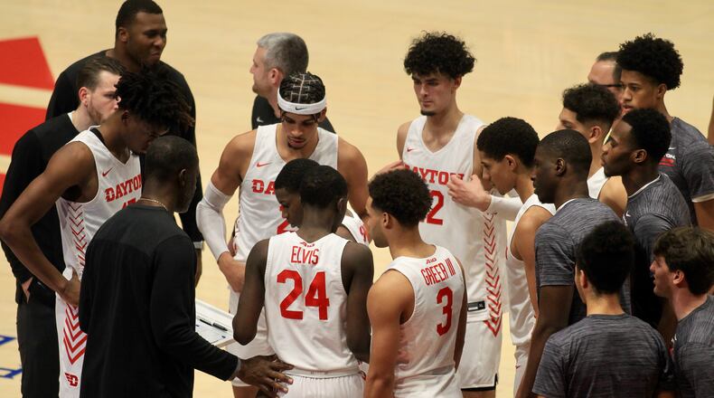 Dayton players huddle around coach Anthony Grant during a game against Alabama State on Wednesday, Dec. 1, 2021, at UD Arena. David Jablonski/Staff