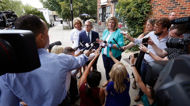 Ohio Governor Mike Dewine and Dayton Mayor Nan Whaley are among Ohio politicians seeking gun legislation that addresses more than mass shooting threats. Here the two spoke Aug. 8 in the Oregon District. TY GREENLEES / STAFF