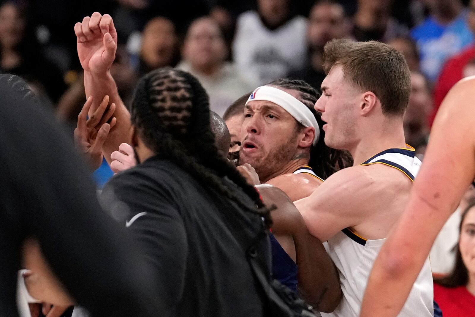 Denver Nuggets forward Aaron Gordon, center, scuffles with members of the Los Angeles Clippers during the first half in Game 4 of an NBA basketball first-round playoff series Saturday, April 26, 2025, in Inglewood, Calif. (AP Photo/Mark J. Terrill)
