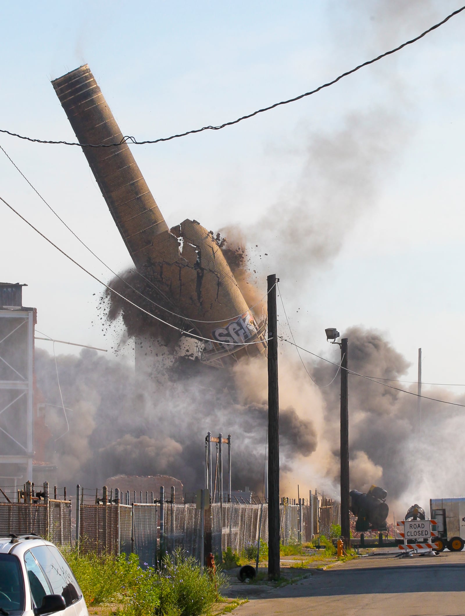 The former Champion Paper and SMART Paper factory smoke stack in Hamilton was demolished on Friday June 27, 2014. GREG LYNCH / STAFF