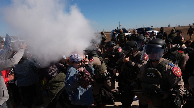 Pepper spray is used by Texas troopers to disperse protesters outside the South Texas Family Residential Center detention facility where Liam Ramos and his father are being detained in Dilley, Texas, Wednesday, Jan. 28, 2026. (AP Photo/Eric Gay)
