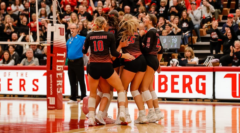 The Tippecanoe High School girls volleyball team celebrates after winning a point during their Division III state semifinal match against Akron Hoban on Friday, Nov. 7 at Wittenberg University's Pam Evans Smith Arena in Springfield. The Red Devils won 3-0. MICHAEL COOPER / STAFF PHOTO