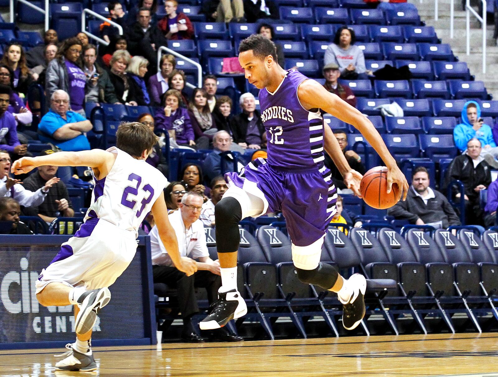 Middletown’s Vincent Edwards (12) fakes out Elder’s Joey Sabato (23) during Friday night’s Division I sectional boys basketball game Feb. 28, 2014, at Xavier University’s Cintas Center in Cincinnati, Ohio. Middletown defeated Elder 54-47. NICK DAGGY / STAFF