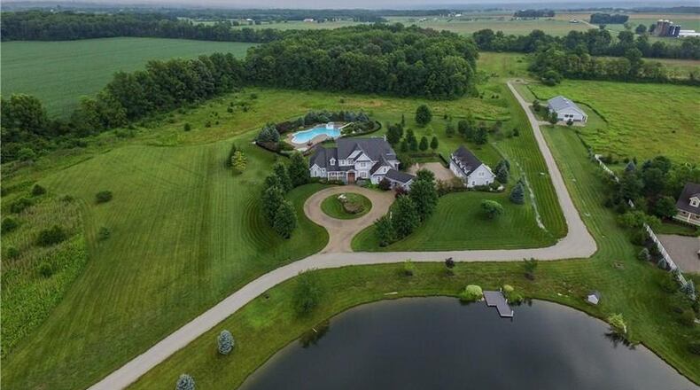 This 5-bedroom rural estate, located at 4950 Utica Road in Clearcreek Twp., features a resort-like pool, stocked pond and 3-stall horse barn. PROVIDED PHOTOS BY ROBINSON SOTHEBY’S INTERNATIONAL REALTY