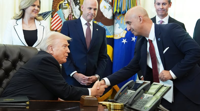President Donald Trump, left, shakes the hand of Novo Nordisk President and CEO Mike Doustdar during an event about drug prices, Thursday, Nov. 6, 2025, in the Oval Office of the White House in Washington. (AP Photo/Evan Vucci)