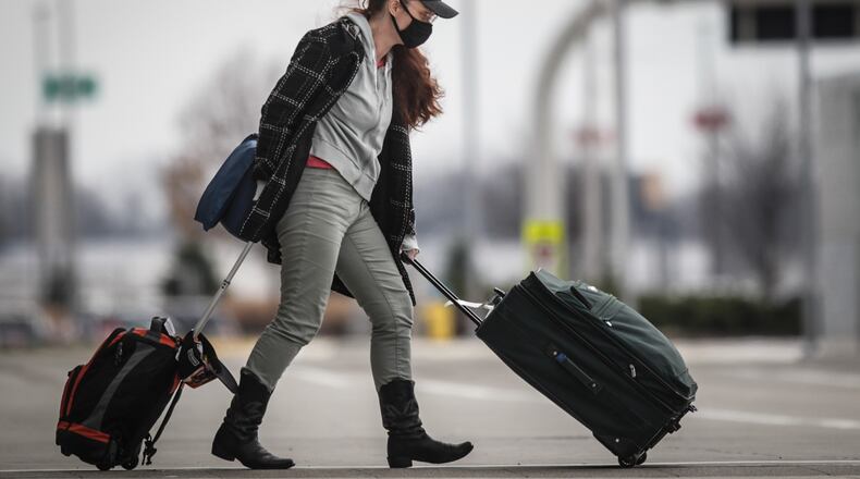 A traveler leaves the Dayton International Airport on Monday Dec. 7, 2020.