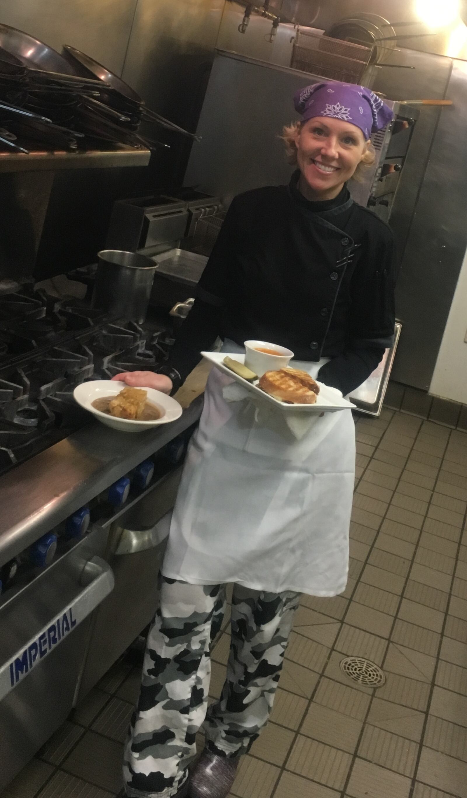 Candace Rinke, chef/owner of the Hawthorn Grill, poses with the restaurant’s grilled cheese and tomato soup dish and bread pudding that is currently on their menu. CONTRIBUTED PHOTO BY ALEXIS LARSEN